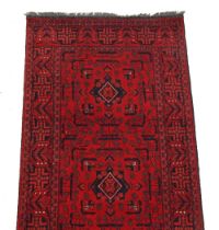 Property of a deceased estate - an Afghan hand knotted wool runner, with red ground, 150 by