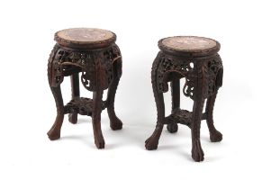 Property of a deceased estate - a pair of Chinese carved hardwood stands with pink marble inset