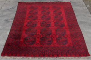 Property of a lady - a Turkoman carpet, with octagonal 'elephant's foot' guls on a dark red