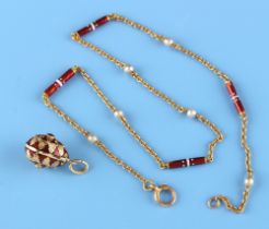 A 14ct gold & red enamel egg pendant, the suspension ring marked '585' and б96 (Russian cyrillic