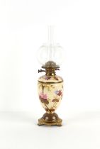 Property of a deceased estate - a late Victorian floral decorated porcelain & brass oil lamp, the