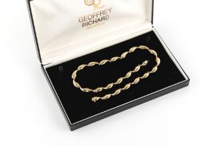 Property of a deceased estate - a modern 9ct yellow gold bean necklace, 15.75ins. (40cms.) long,