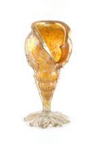 Property of a deceased estate - Loetz - an iridescent glass vase modelled as a conch shell, 11.8ins.