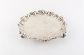 Property of a lady - a George IV silver salver or waiter, with acanthus decorated scroll feet, split