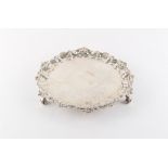 Property of a lady - a George IV silver salver or waiter, with acanthus decorated scroll feet, split