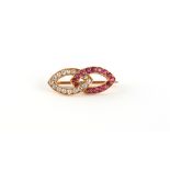 An Edwardian unmarked high carat gold ruby & diamond brooch in the form of two linked ovals,