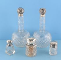 Property of a gentleman - a pair of early 20th century silver topped cut glass scent bottles, with