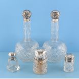 Property of a gentleman - a pair of early 20th century silver topped cut glass scent bottles, with