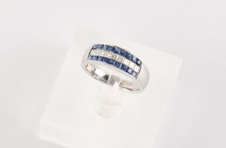 An 18ct white gold sapphire & diamond three row ring, set with a central row of nine princess cut
