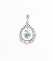An unmarked white gold aquamarine & diamond pendant, the suspended oval cut aquamarine weighing