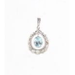 An unmarked white gold aquamarine & diamond pendant, the suspended oval cut aquamarine weighing