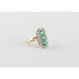 An Art Deco style yellow gold emerald & diamond ring, the elongated rectangular panel set with three