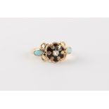 A 19th century unmarked yellow gold opal diamond & black enamel ring, the black enamel flowerhead