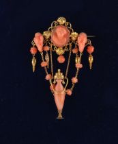 A good Victorian unmarked high carat gold carved coral brooch, with central oval coral cameo