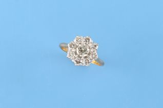 An unmarked 18ct yellow gold (tested) diamond cluster ring, the nine round brilliant cut diamonds