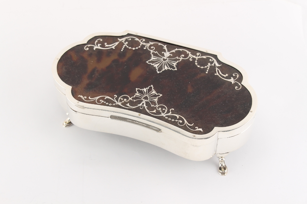 An early 20th century silver & tortoiseshell shaped jewellery box, with lined interior & hoof
