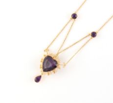 A yellow gold cannetille amethyst necklace, the heart shaped cut amethyst measuring approximately 15
