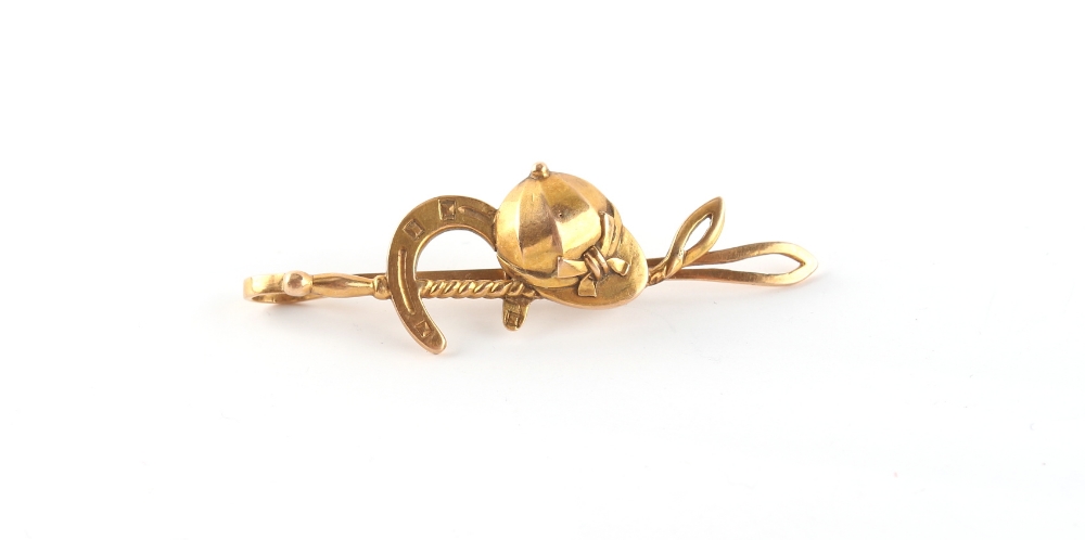 Property of a lady - an 18ct yellow gold jockey cap, horseshoe & whip bar brooch, approximately 6.