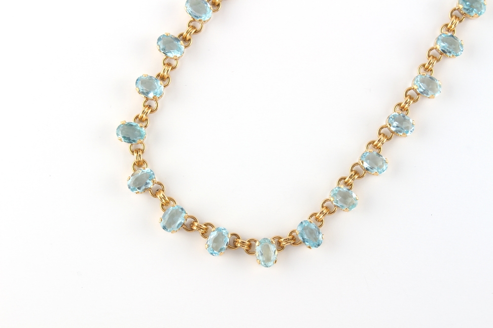 An unmarked yellow gold (tests 18ct) aquamarine riviere necklace, the thirty-six oval cut - Image 2 of 2