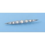 An 18ct white gold diamond & pearl stock pin or long brooch, the largest pearl measuring