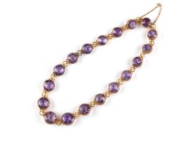 Property of a lady - a late Victorian unmarked yellow gold (tests 15ct) amethyst riviere necklace,