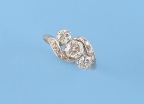A yellow gold diamond crossover ring, the centre stone approximately 0.45 carat, size K.