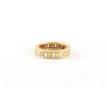 Property of a lady - an unmarked 18ct yellow gold (tested) yellow & white diamond eternity ring, set