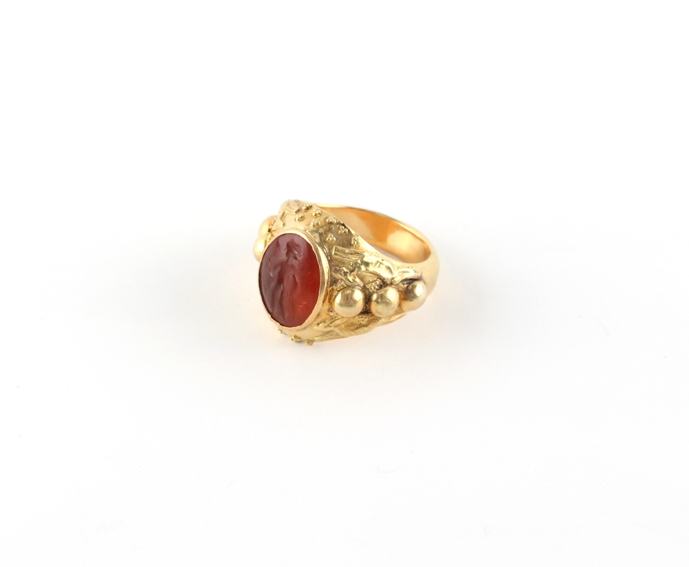 An unmarked high carat yellow gold ring set with an antique carved carnelian intaglio, approximately - Image 2 of 2