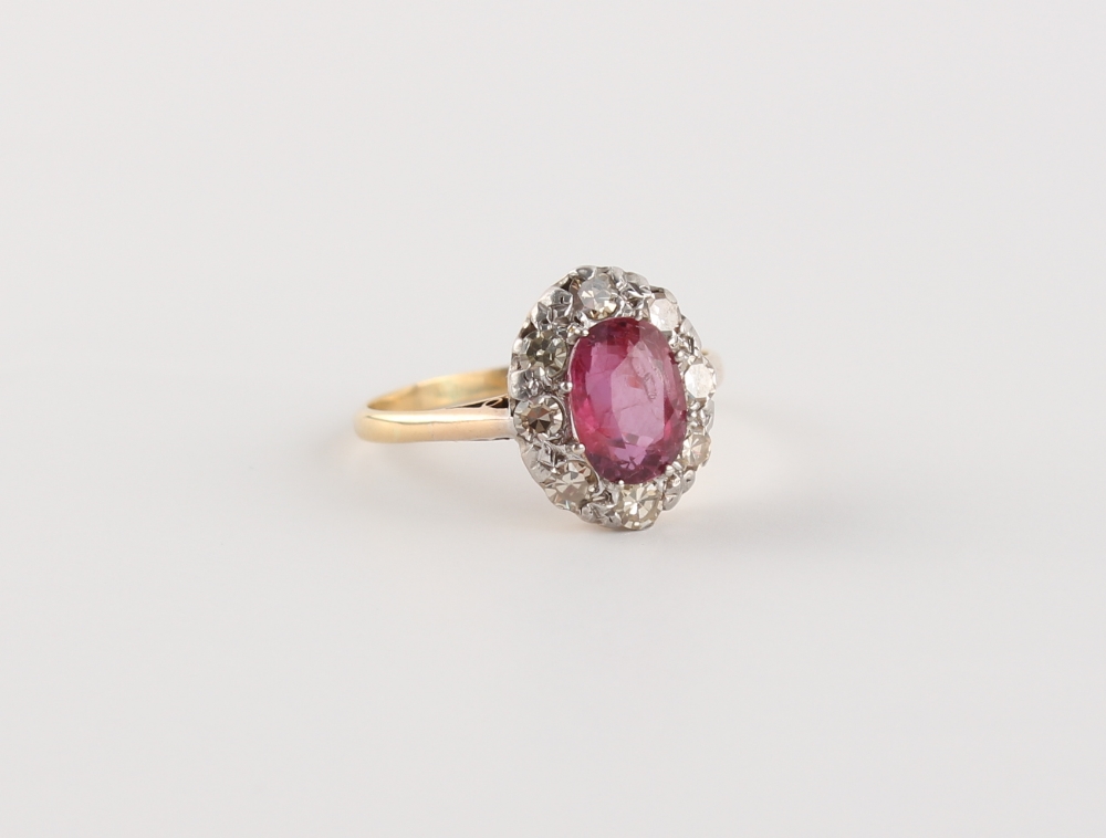 An 18ct yellow gold ruby & diamond oval cluster ring, the oval cushion cut ruby weighing - Image 2 of 2