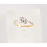 An 18ct yellow gold & platinum diamond two-stone ring, with square setting, size M/N.