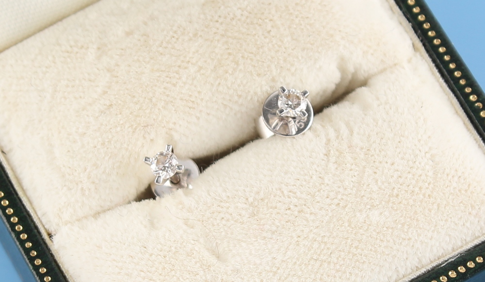 Property of a lady - a pair of 18ct white gold diamond stud earrings, the round brilliant cut