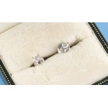 Property of a lady - a pair of 18ct white gold diamond stud earrings, the round brilliant cut