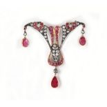 A Belle Epoque style ruby & diamond brooch, set with a pear shaped ruby, two oval cushion cut rubies