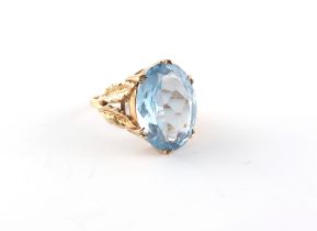 Property of a lady - a 9ct yellow gold synthetic blue spinel ring, the oval cut stone measuring