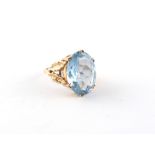 Property of a lady - a 9ct yellow gold synthetic blue spinel ring, the oval cut stone measuring