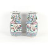 Property of a lady - a pair of late 19th century Chinese Canton famille rose vases, one with re-