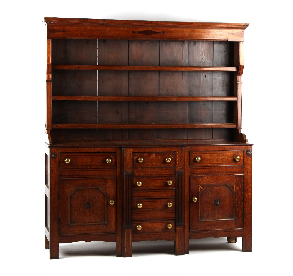 A George III oak two-part Welsh dresser, Anglesey region, with plate rack above breakfront base