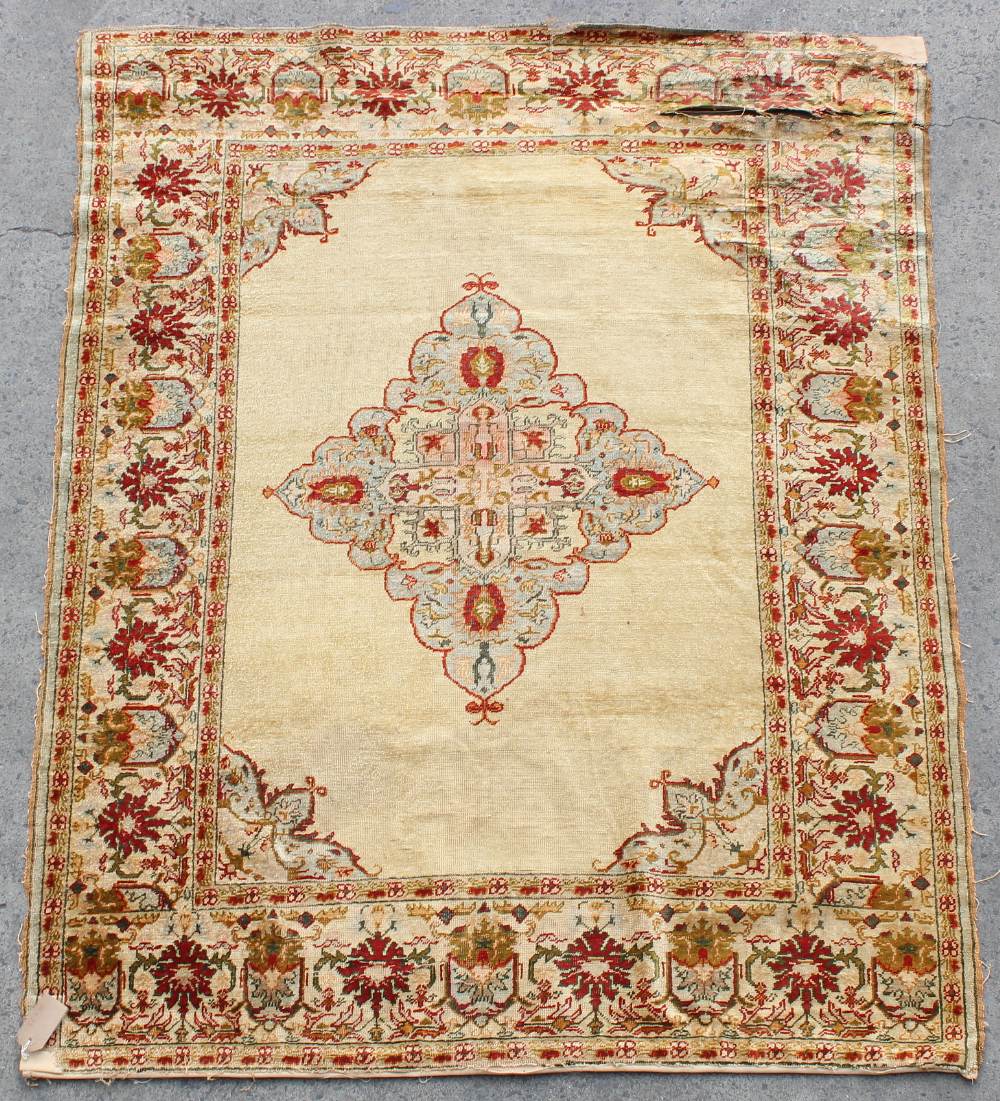 Property of a lady - an antique Turkish Kayseri silk rug, damages, 62 by 46ins. (158 by 117cms.).
