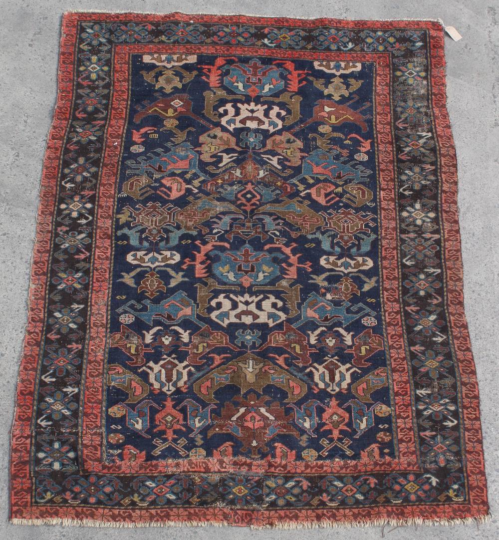 Property of a lady - a Caucasian rug, early 20th century, with navy ground, 77 by 55ins. (196 by