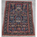 Property of a lady - a Caucasian rug, early 20th century, with navy ground, 77 by 55ins. (196 by