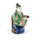 Property of a lady - a Japanese Kutani porcelain figure of a kneeling man holding a shoe, Meiji