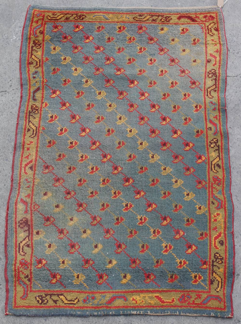 Property of a lady - a Donegal rug, with blue ground, 64 by 40ins. (163 by 102cms.).