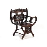 A late 19th century Chinese carved hongmu armchair, the arms carved in relief with prunus, with