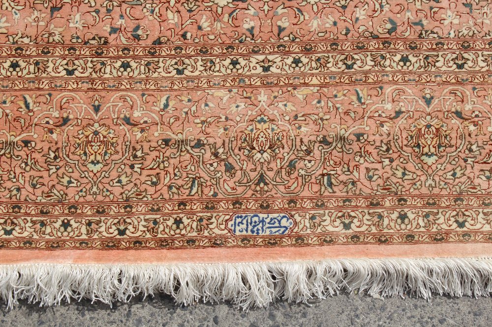 Property of a lady - a fine Persian Qum silk carpet, with pale pink ground, signed to one end in - Image 3 of 5