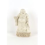 Property of a deceased estate - a Chinese blanc de Chine figure of Budai, modelled standing, early