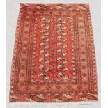 Property of a deceased estate - a Turkoman rug, with two rows of octagonal guls, 74 by 53ins. (188