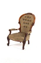 Property of a deceased estate - a Victorian carved walnut upholstered spoon-back armchair, with