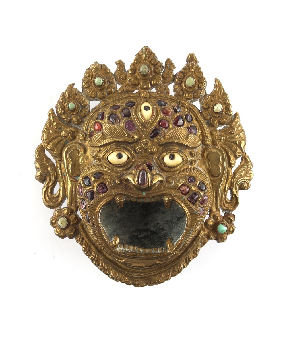 Property of a deceased estate - a Tibetan brass Mahakala mask incense burner, 19th century, inlaid