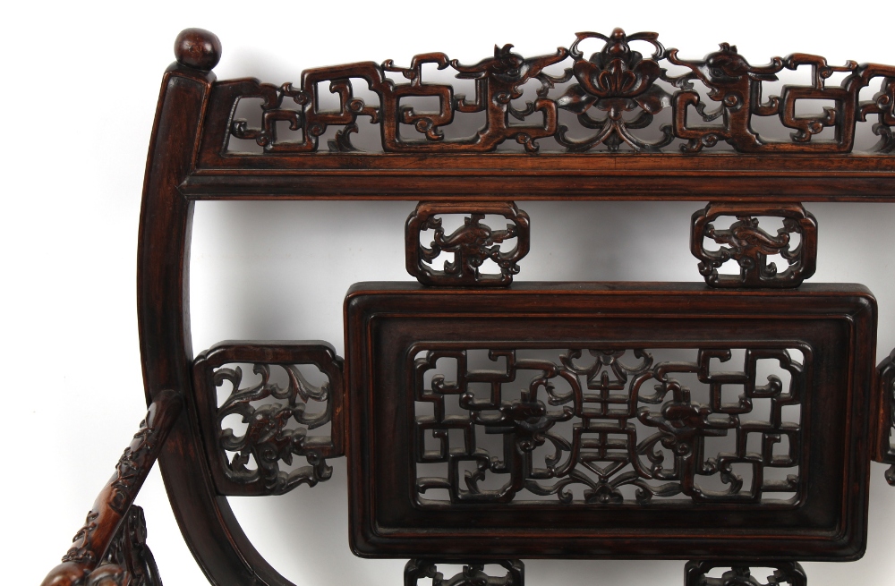 A late 19th century Chinese carved hongmu armchair, the arms carved in relief with prunus, with - Image 4 of 5