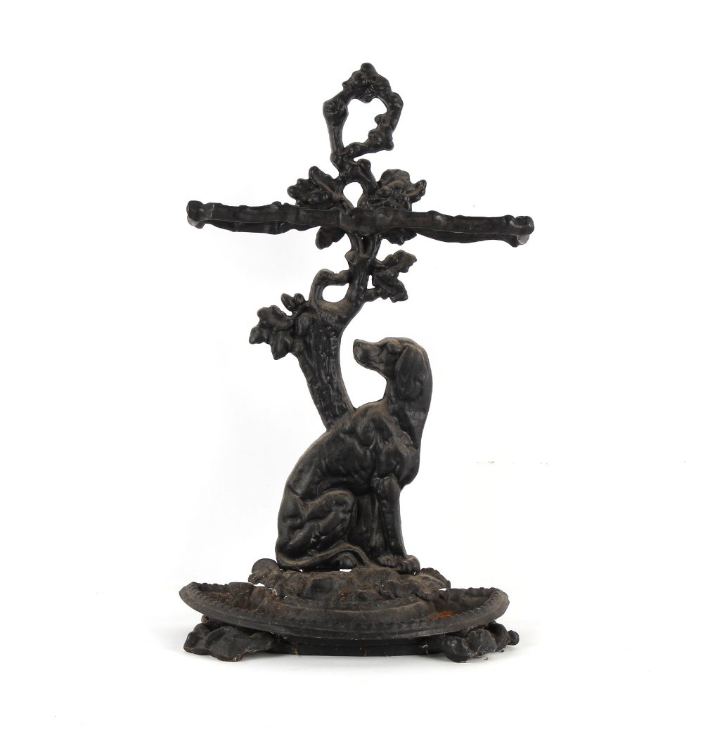 Property of a lady - a black painted ornate cast iron hound stick stand, with loose tray.